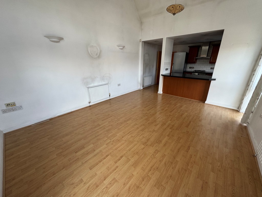 Lot: 15 - TWO-BEDROOM APARTMENT - Living room looking towards the kitchen